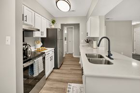 Augusta apartment for rent - A kitchen with a white counter top and a black faucet.