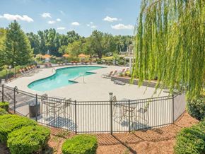 Augusta apartment for rent - a view of a pool with a fence and chairs around it