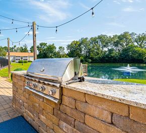 Augusta apartment for rent - A BBQ grill is on a brick wall next to a body of water.