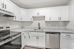 Augusta apartment for rent - A kitchen with white cabinets and granite countertops.