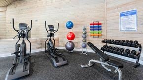 Augusta apartment for rent - A fitness center with exercise equipment and a sign on the wall.