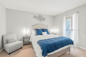 Augusta apartment for rent - A bedroom with a bed, chair, and two lamps.