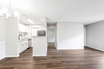 Augusta apartment for rent - A kitchen with white cabinets and a wooden floor.