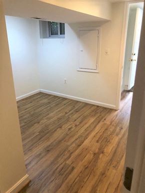 Washington apartment for rent - an empty room with a white wall and wooden floors