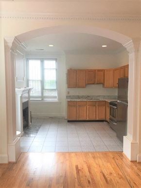 Washington apartment for rent - an empty kitchen with wooden cabinets and a wood floor