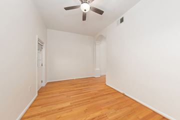 Washington apartment for rent - a living room with white walls and wood flooring and a ceiling fan