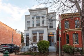 Washington apartment for rent - the exterior of a house with a white facade and a black fence