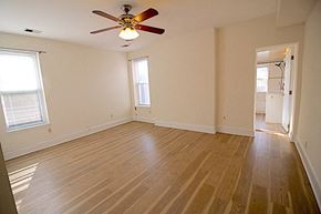 Washington apartment for rent - an empty living room with a ceiling fan