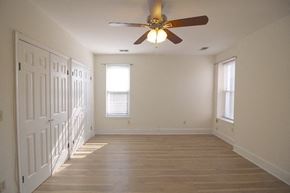 Washington apartment for rent - a empty room with a ceiling fan and a door