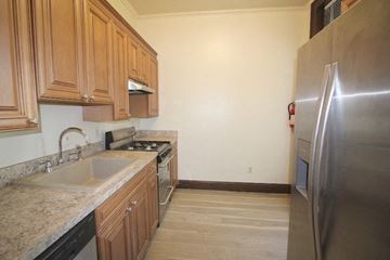 Washington apartment for rent - a kitchen with a sink and a stainless steel refrigerator