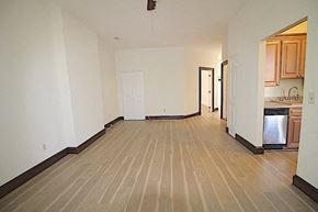 Washington apartment for rent - an empty living room and kitchen with a wood floor