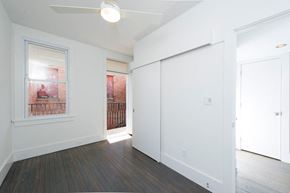 Washington apartment for rent - an empty living room with white walls and a door to a balcony