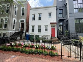 Washington apartment for rent - a white house with a red door behind a garden