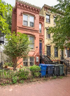 Washington apartment for rent - a red brick house with a fence in front of it