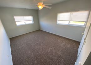 Clinton apartment for rent - a bedroom with a carpeted floor and a ceiling fan