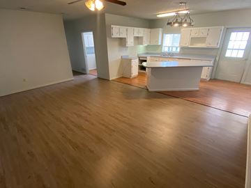 Clinton apartment for rent - an open kitchen and living room with wood flooring