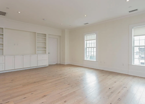 Darien apartment for rent - A large empty room with wooden floors and white walls.