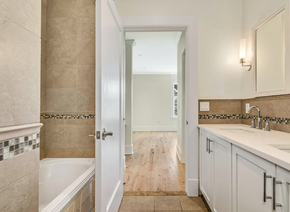 Darien apartment for rent - A bathroom with a white door and a tiled wall.