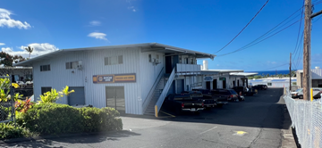 Kailua-Kona apartment for rent - a building with a parking lot and cars parked in front of it