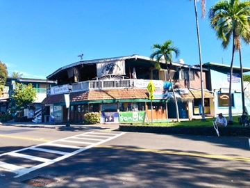Kailua Kona apartment for rent - a building on the corner of a street with palm trees