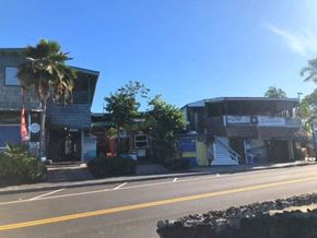 Kailua Kona apartment for rent - a building with a palm tree on the side of a street