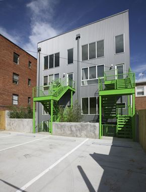 Washington apartment for rent - A white building with green stairs in front.