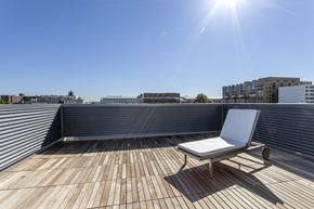 Washington apartment for rent - A white chair is on a wooden deck with a sunny sky in the background.