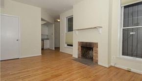 Washington apartment for rent - a living room with a fireplace and a wooden floor