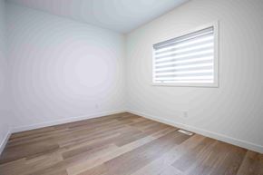 Winnipeg apartment for rent - A room with wooden flooring and a window with blinds.