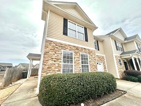 Greer house for rent - A house with a stone wall and a white door.