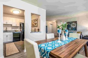 Towson apartment for rent - A dining room with a wooden table and chairs.