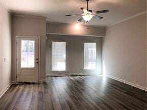 Aiken house for rent - A room with a ceiling fan and wooden flooring.