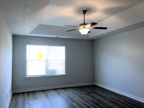 Aiken house for rent - A room with a ceiling fan and a window with blinds.