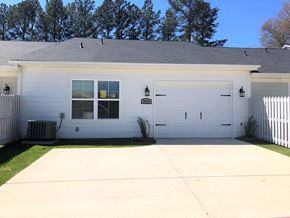 Aiken house for rent - A white house with a grey roof and a white fence.