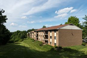 Timonium apartment for rent - A large apartment complex with a grassy area in front.