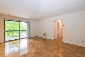Timonium apartment for rent - A room with a wooden floor and a sliding glass door.