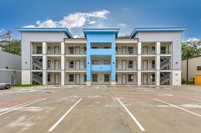 Spring apartment for rent - a parking lot in front of an apartment building