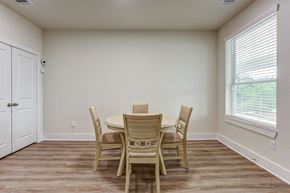 Spring apartment for rent - a dining room with a table and chairs and a window