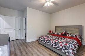 Spring apartment for rent - a bedroom with a bed and a ceiling fan
