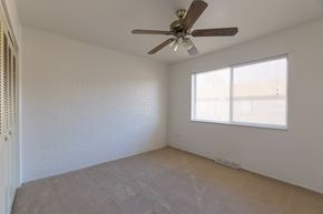 Lakewood apartment for rent - an empty room with a ceiling fan and a window