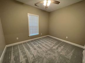 Wilson apartment for rent - A room with a carpeted floor and a window.