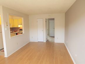 Arvada apartment for rent - an empty living room with white walls and wood floors