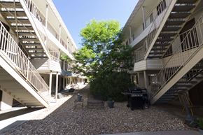 Arvada apartment for rent - the courtyard between the buildings has a grill and a tree