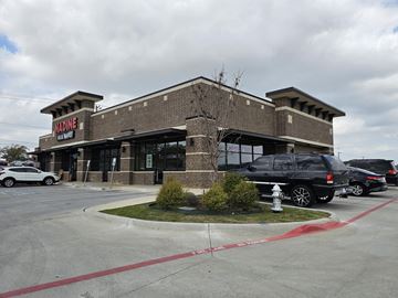 Euless apartment for rent - A Madine storefront with a black SUV parked in front.