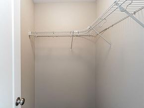 West Des Moines apartment for rent - A white closet with a metal rack hanging on the wall.