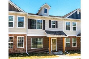 West Des Moines apartment for rent - a white house with a black roof and a red brick