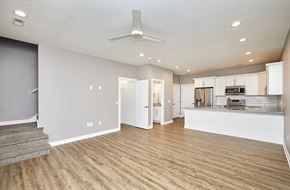 Waukee apartment for rent - A spacious kitchen with a staircase on the left side.