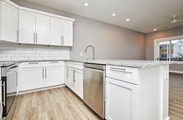 Waukee apartment for rent - A kitchen with white cabinets and appliances.