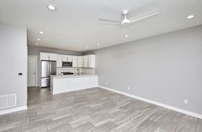 Waukee apartment for rent - A spacious kitchen with a fan on the ceiling.
