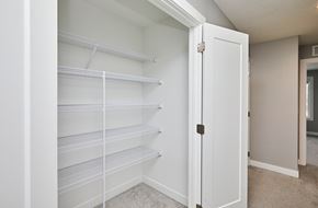 Waukee apartment for rent - A white pantry with a white door is open.